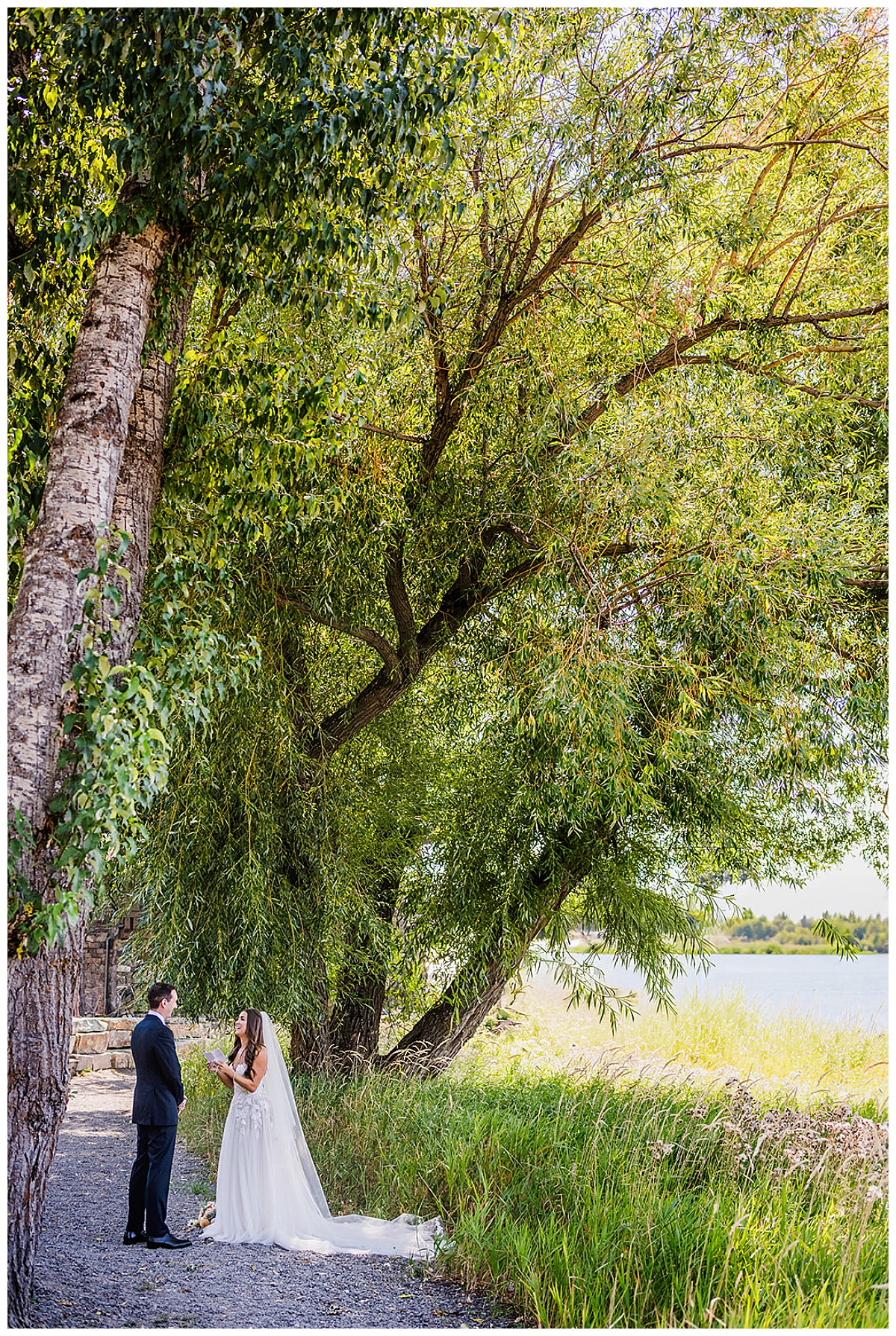 Bride and Groom sharing their vows under a big tree before a wedding at The Lodge at Whitefish Lake in Whitefish, MT.