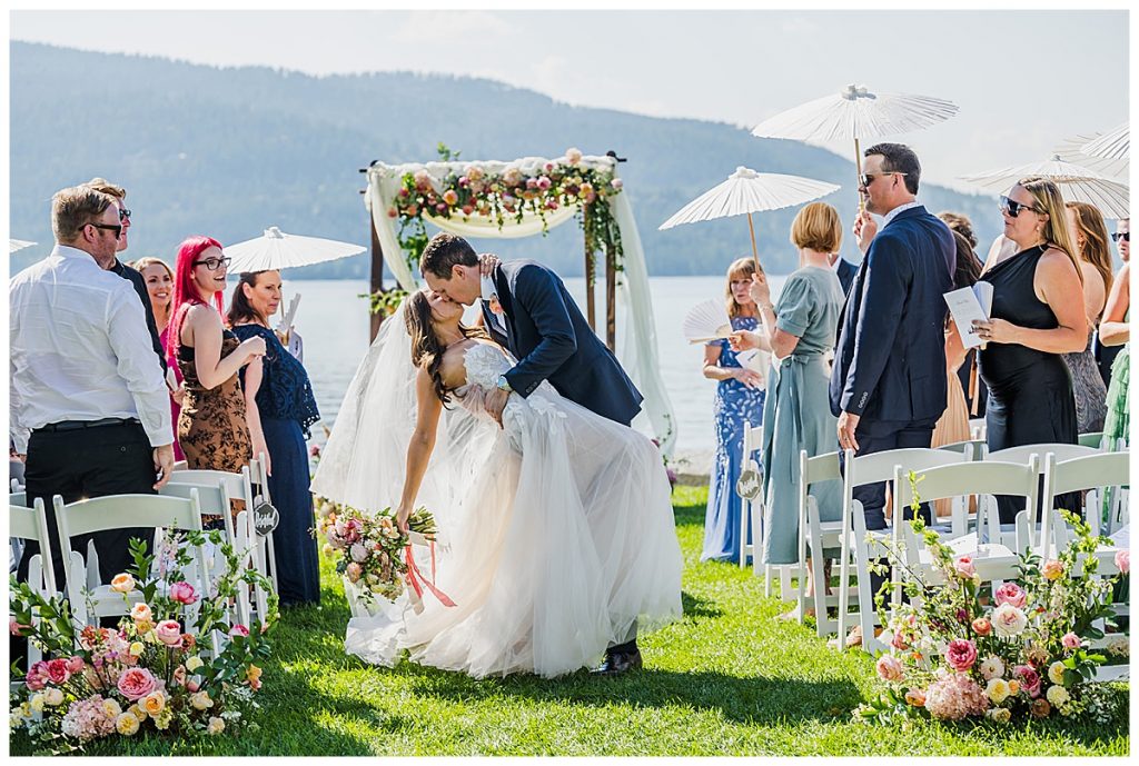 Bride and Groom kissing as the walk down the aisle after their wedding ceremony at The Lodge at Whitefish Lake, in Whitefish, MT.