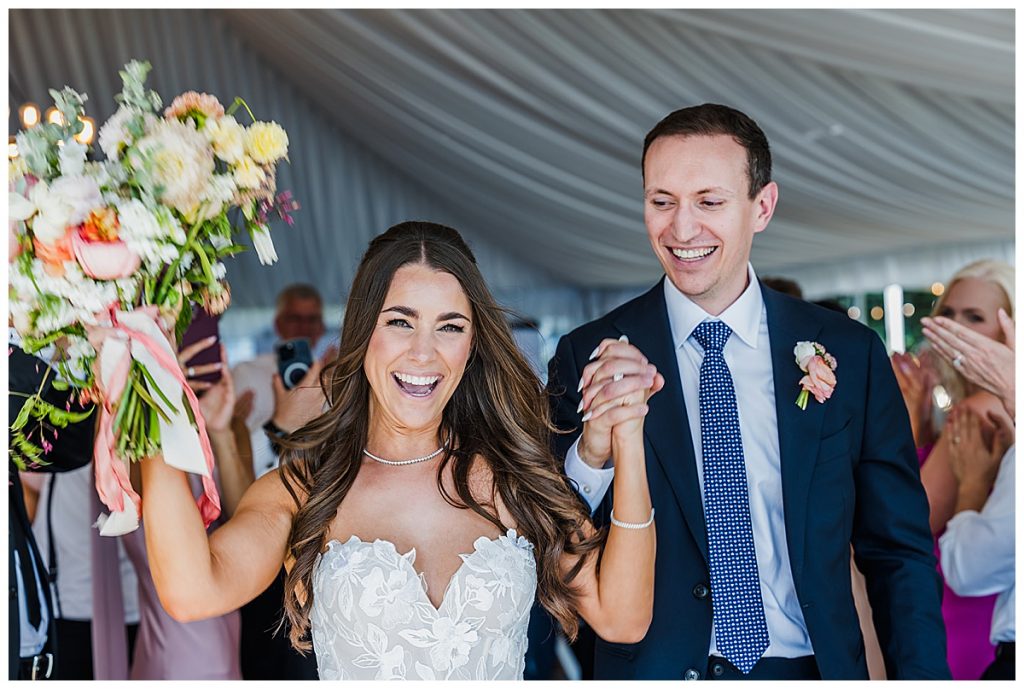 Bride and Groom entering their reception at their wedding at The Lodge at Whitefish Lake, in Whitefish, MT.