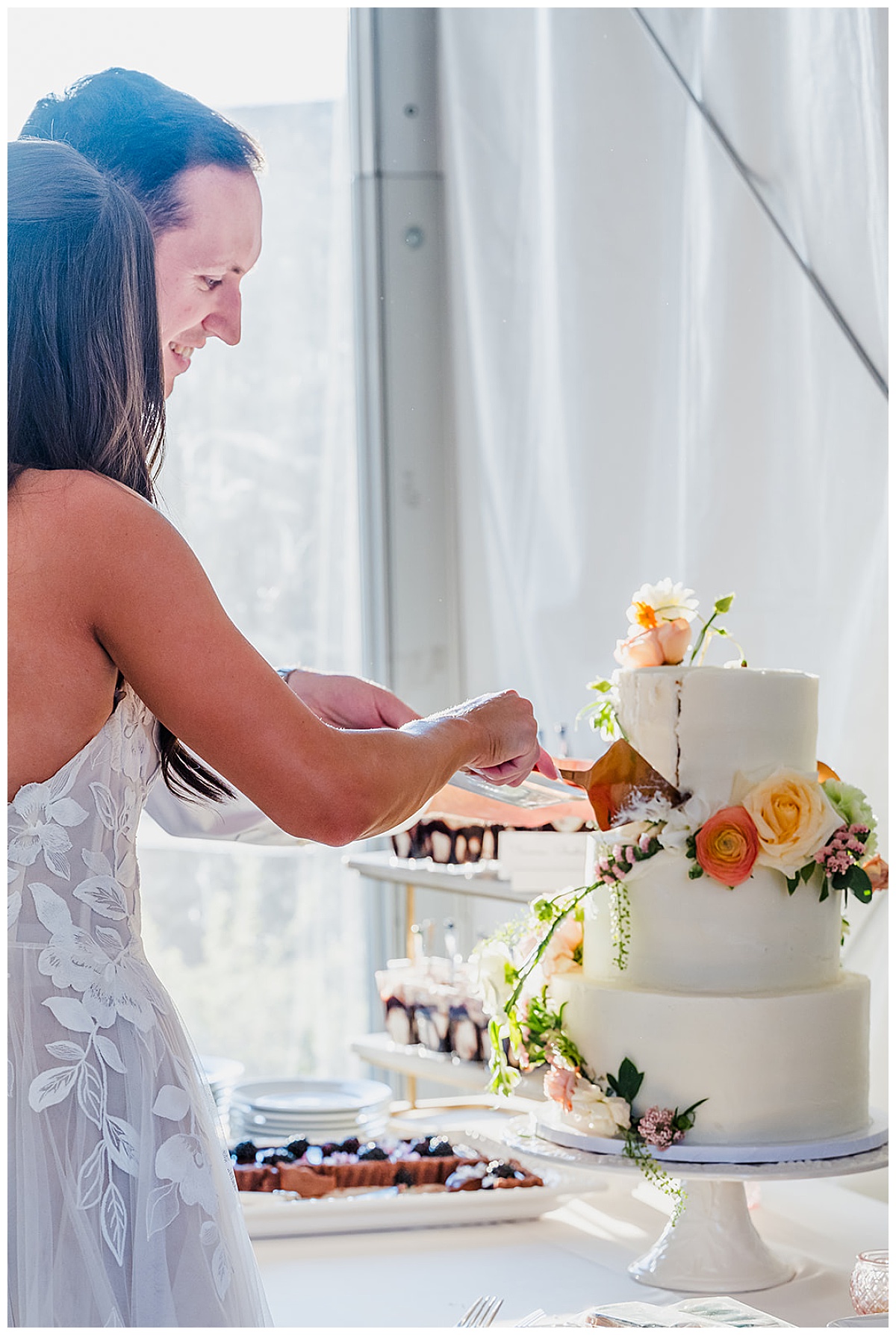 Bride and Groom cutting their cake during their wedding reception at The Lodge at Whitefish Lake, in Whitefish, MT.